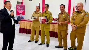 Cornelis menyerahkan buku hukum desa kepada kepala desa di Sengah Temila